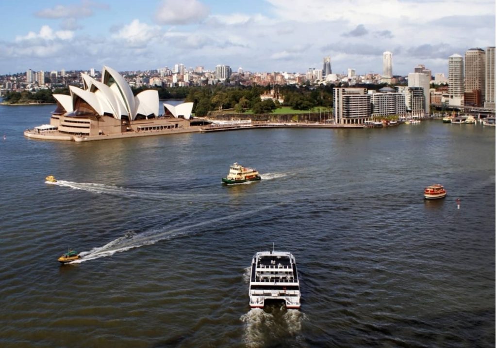 A scenic panoramic view of the Sydney Opera House and Harbour Bridge representing an Australian education campus location.
